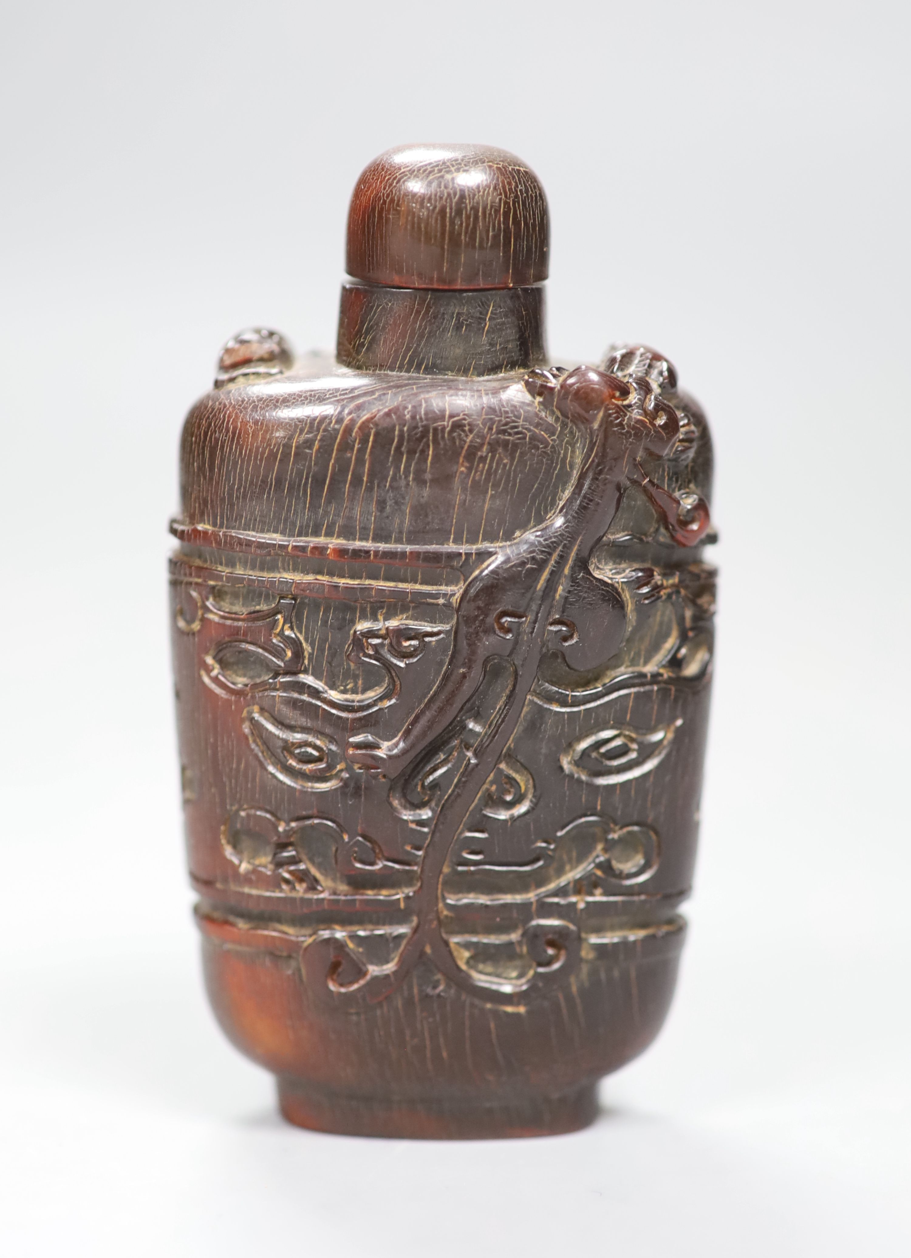 A Chinese archaistic horn snuff bottle and stopper, height 9.5cm